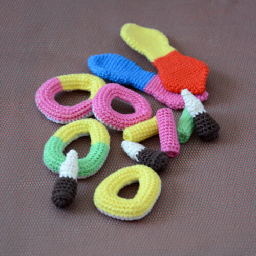 Gros plan sur plusieurs variétés de bonbons crochetés (bouteille de cola, anneaux apollo, frites, langue de chat)